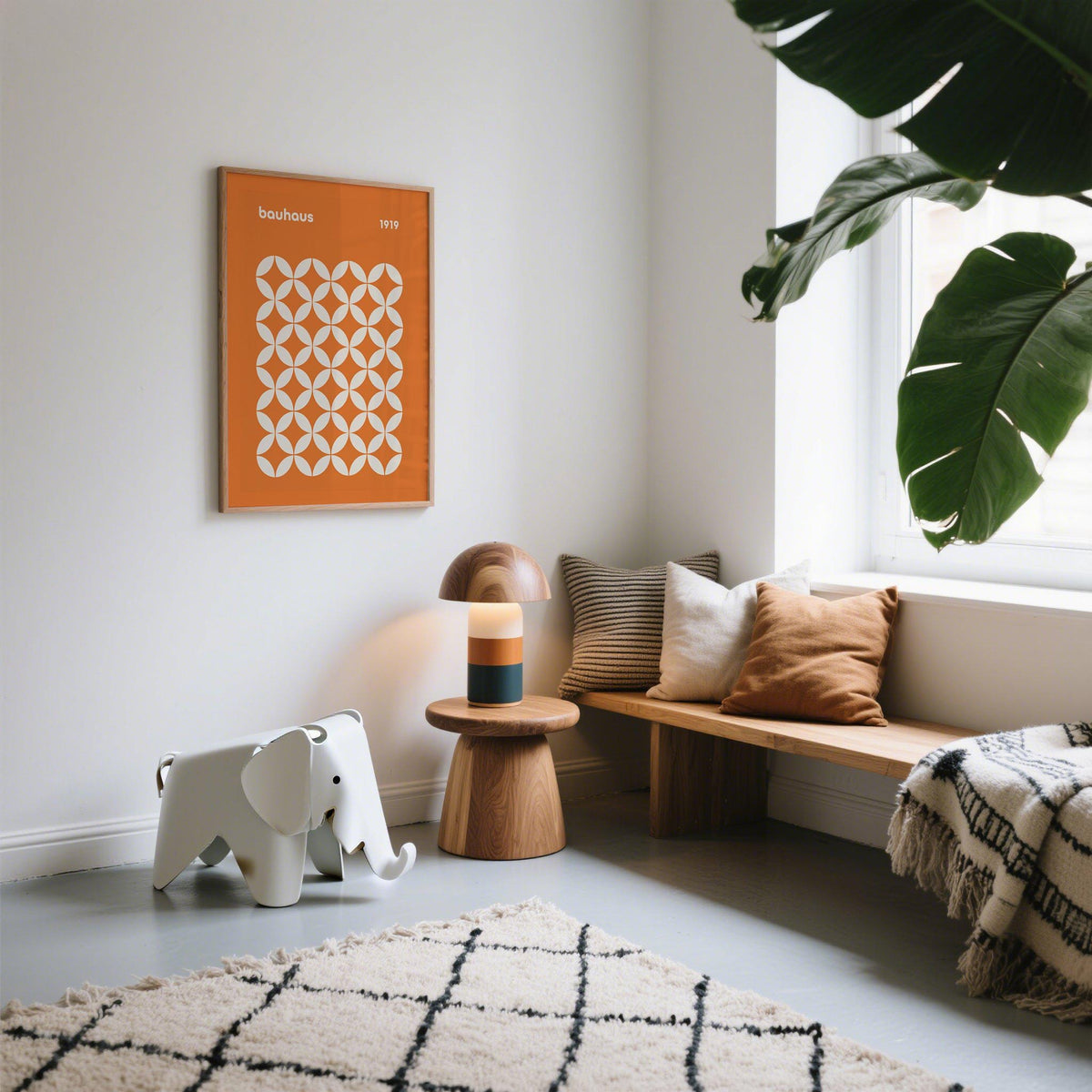 Print on a wall of an orange circle grid poster in a neutral living area with a plant and wooden table