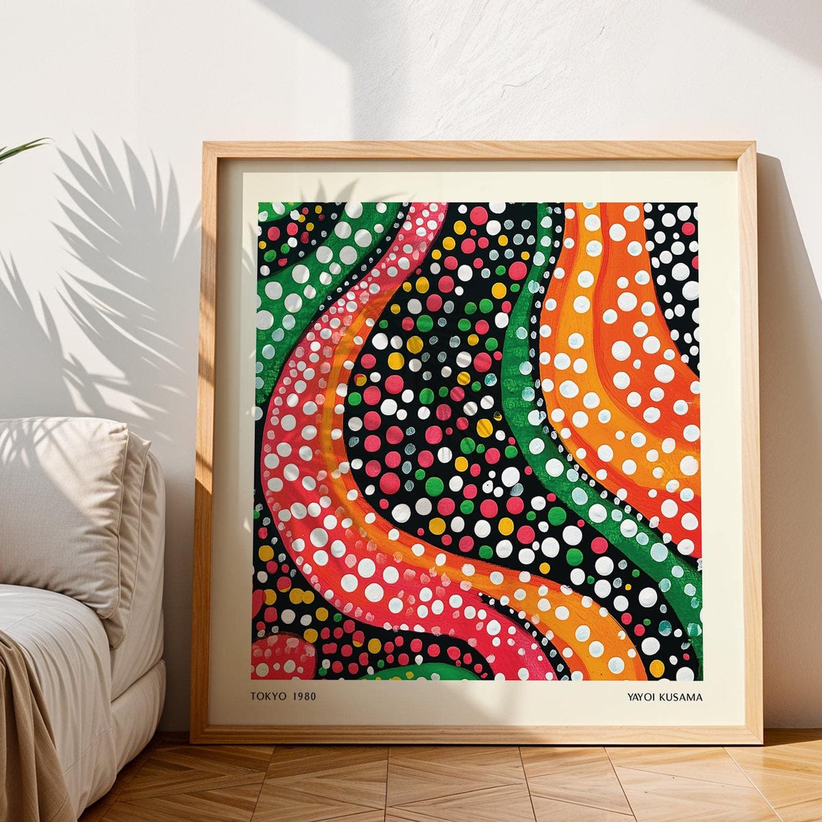 Framed Abstract Colorful Art with wavy lines and dots in bright green orange and pink leaning on a wooden floor near a sofa