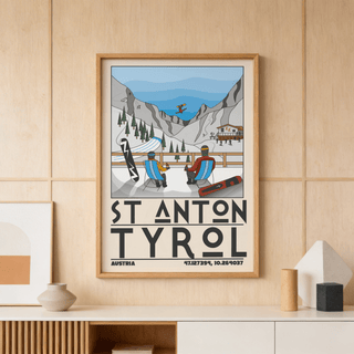 Framed St Anton Tyrol art print showing a minimalist ski resort scene with two figures in chairs and mountains