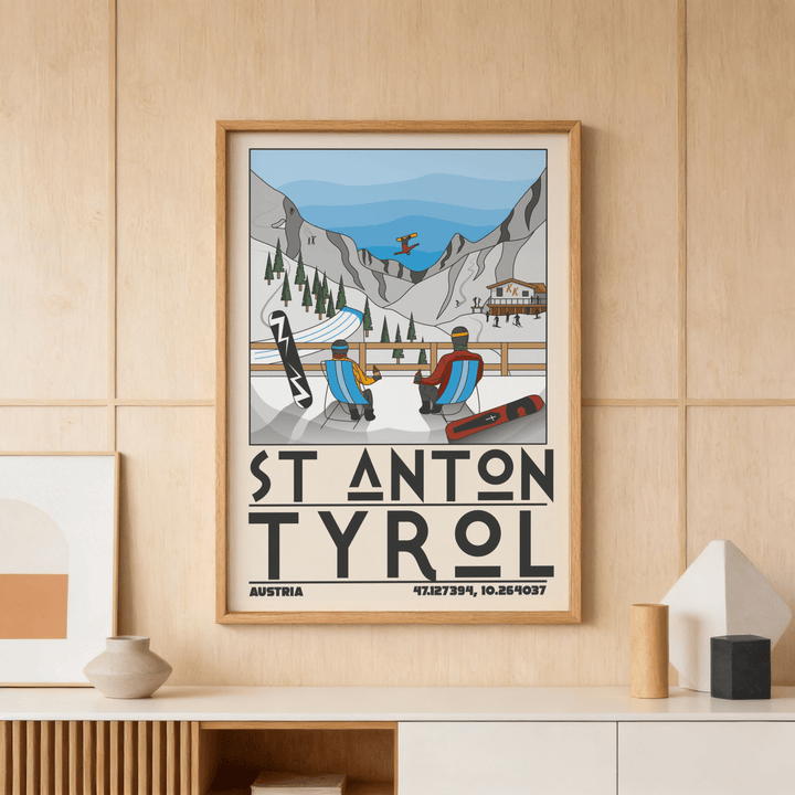 Framed St Anton Tyrol art print showing a minimalist ski resort scene with two figures in chairs and mountains