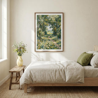 Impressionist art print of a woodland path with green and yellow foliage in a bedroom above a bed