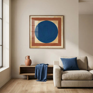 Minimalist Circle Art print with blue circle and brown square above a wooden side table with a jug in a living room