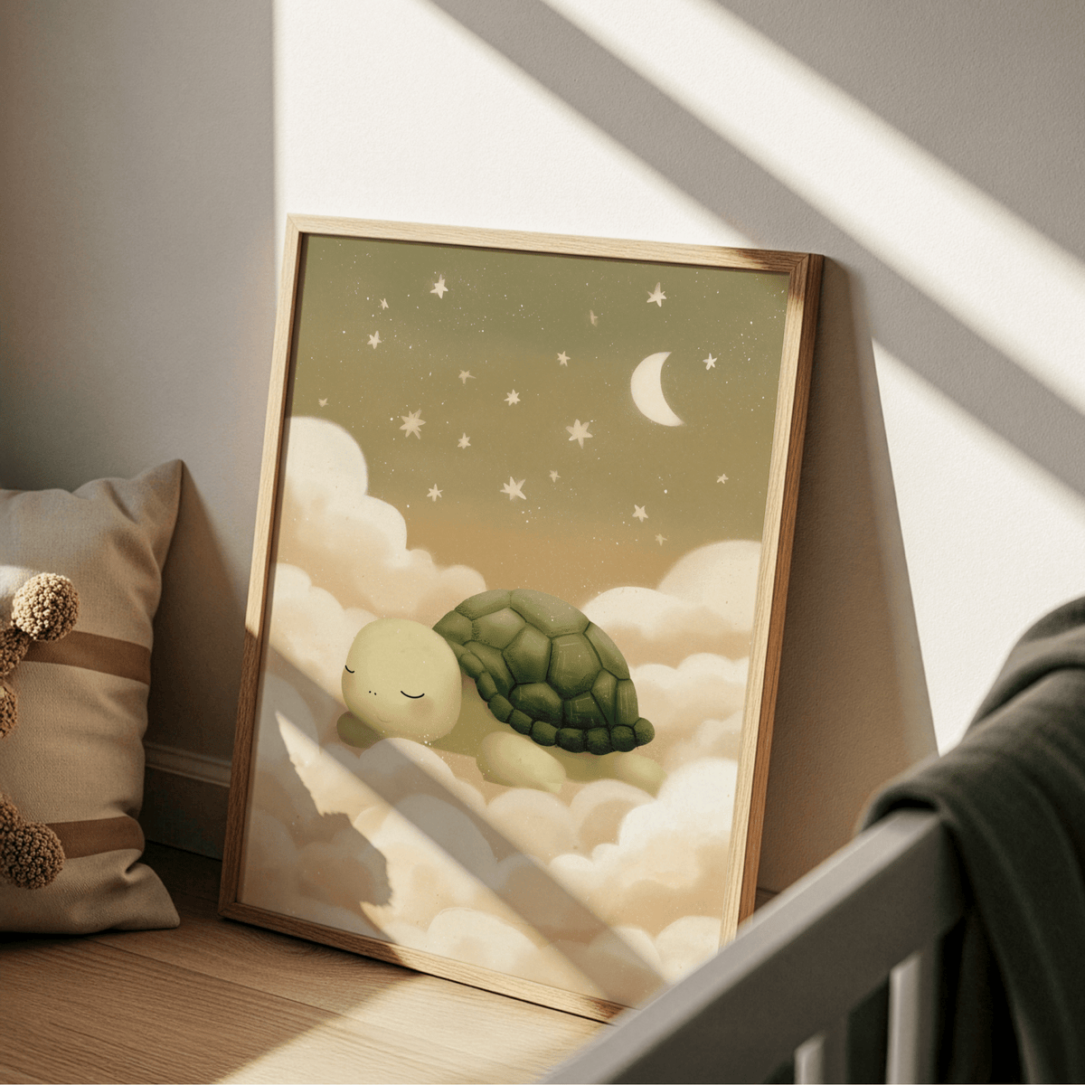 Print leaning on a floor showing turtle wall art of a sleeping turtle with green and cream tones near a brown cushion