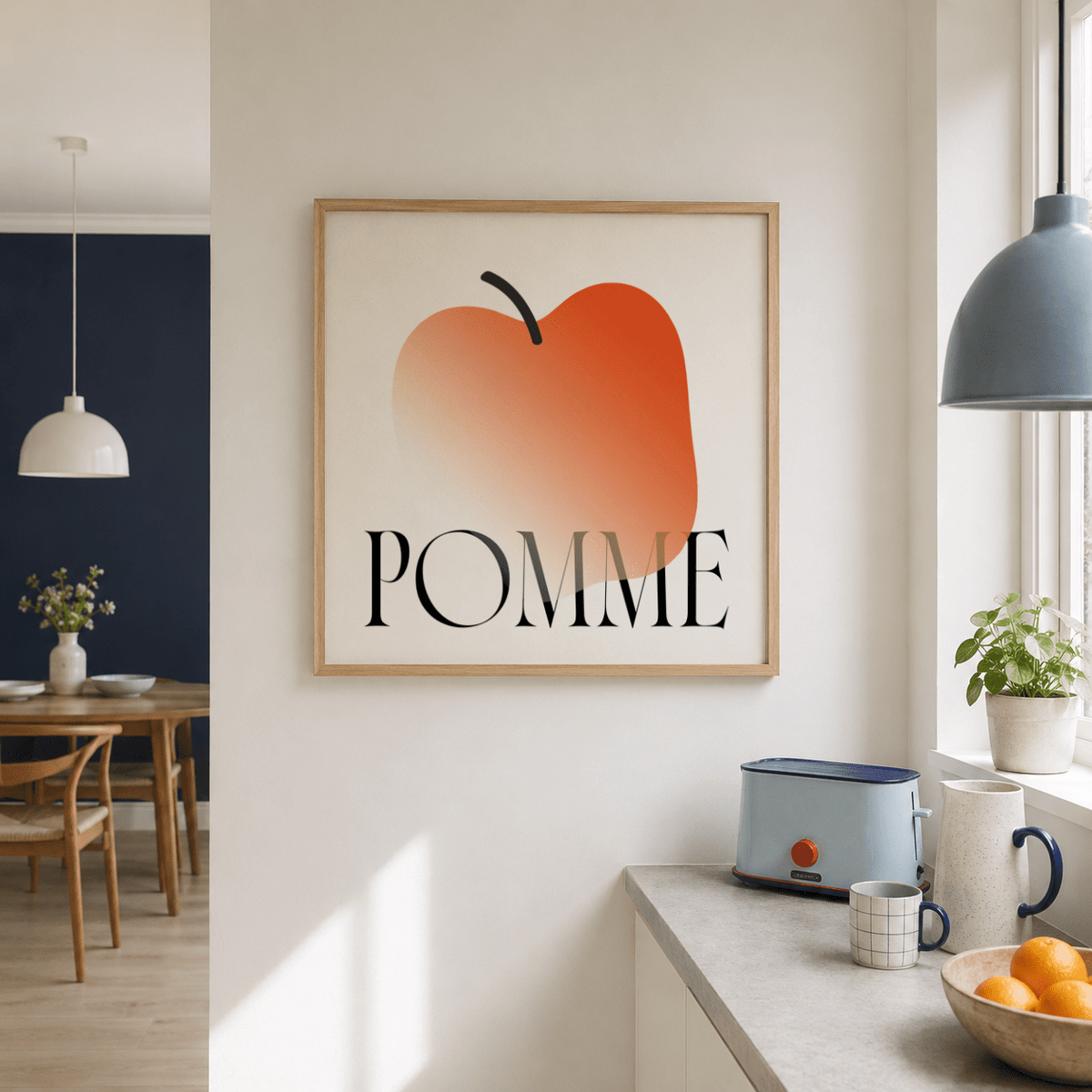 Minimalist Apple Art Print with bright orange abstract apple on a kitchen wall near a toaster and cups