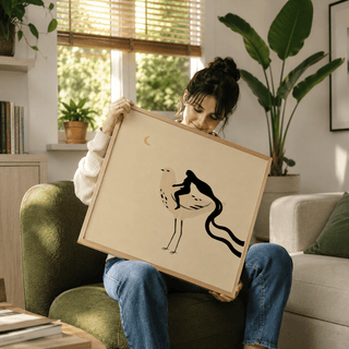 Framed Whimsical Bird Art Print with a woman riding a bird in beige and black held by a woman