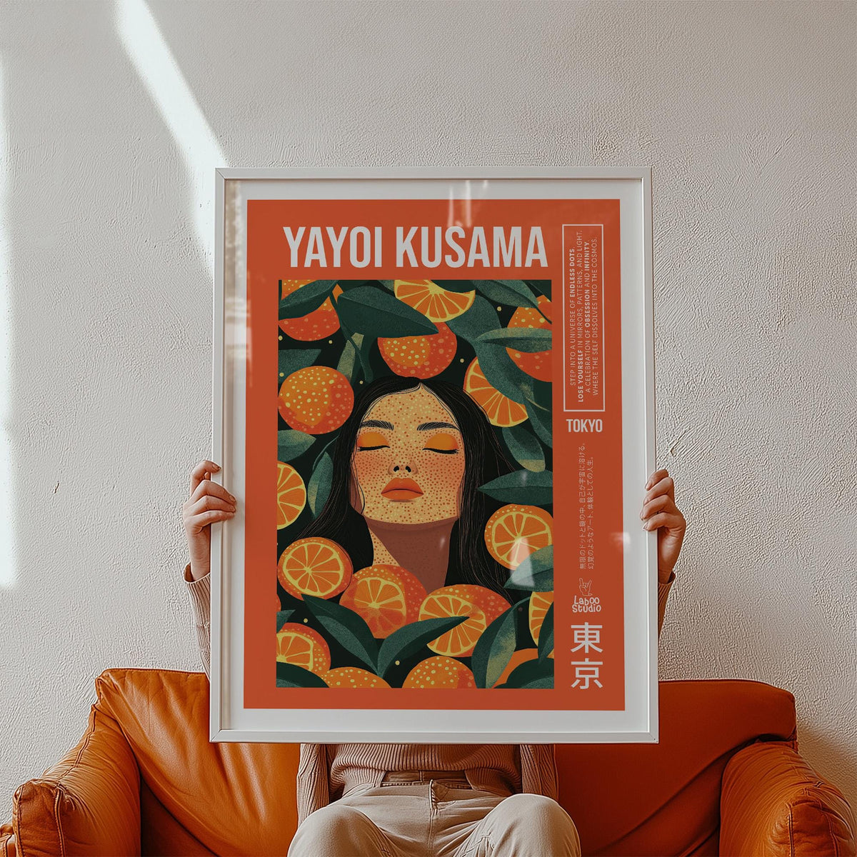 Cool Wall Art framed print of a woman with orange slices in warm orange and green tones held above a brown leather chair