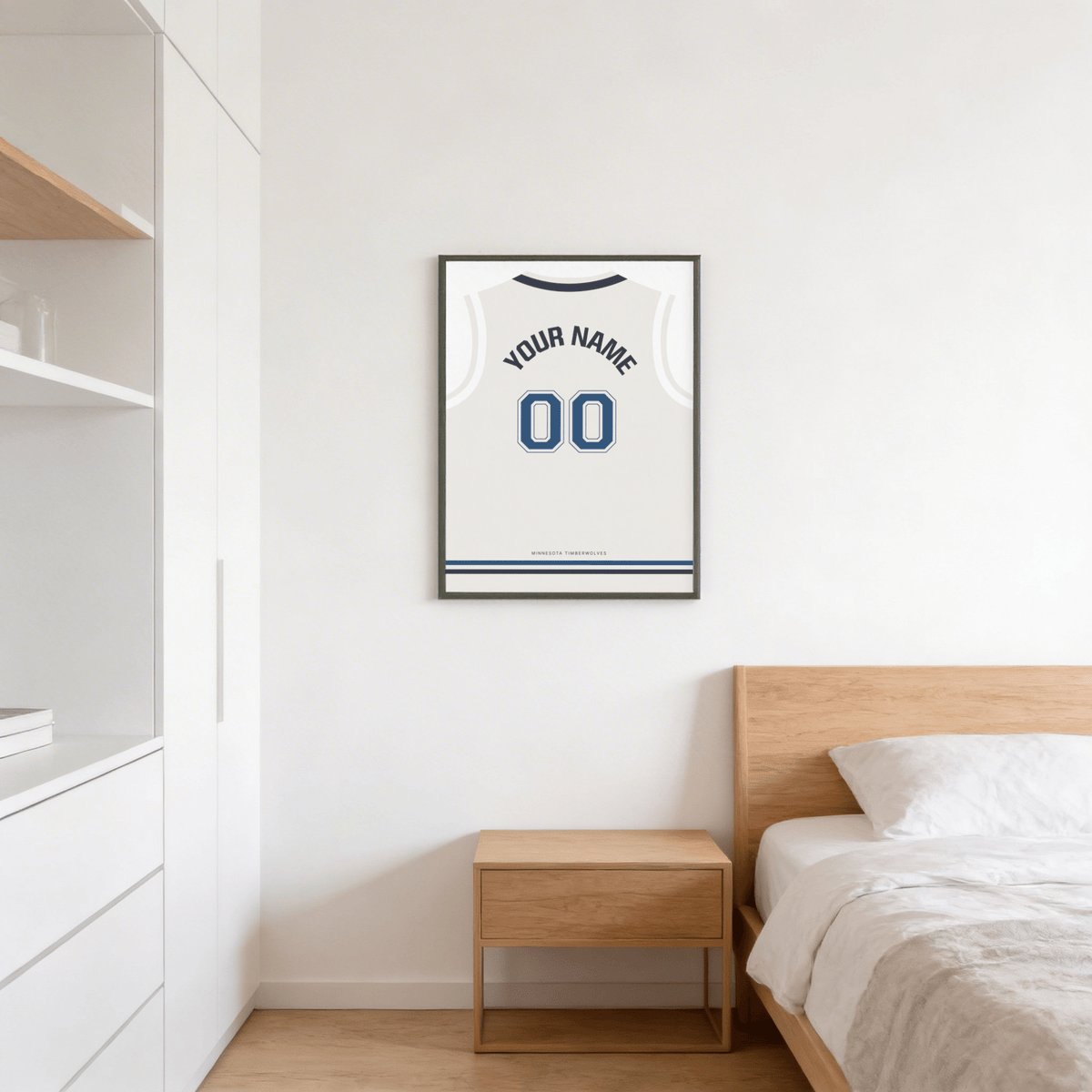 Basketball Jersey Poster in White with Navy Number hanging above a wooden bedside table in a bedroom