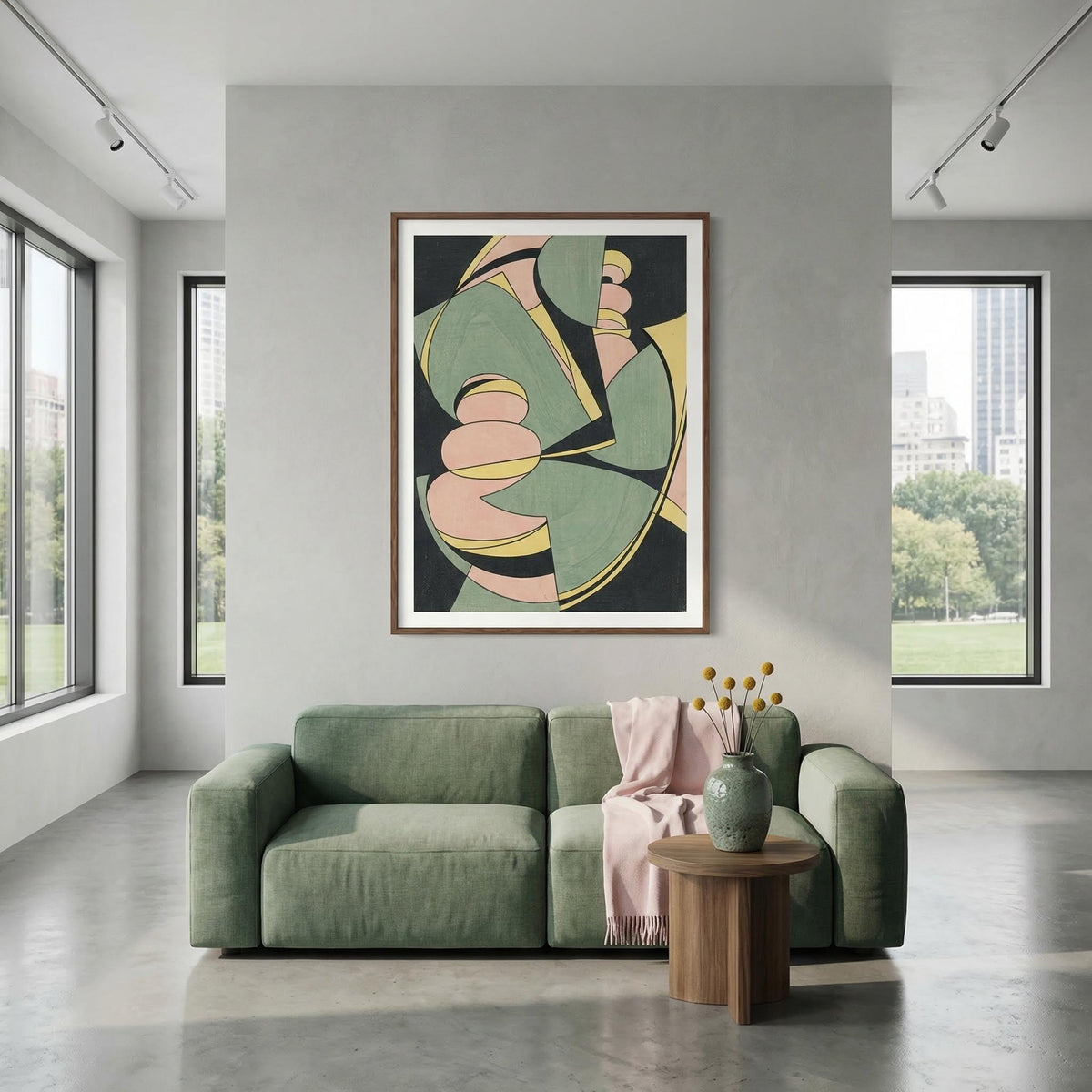 Abstract Geometric Art Print in muted green, yellow and pink above a green sofa in a modern living room