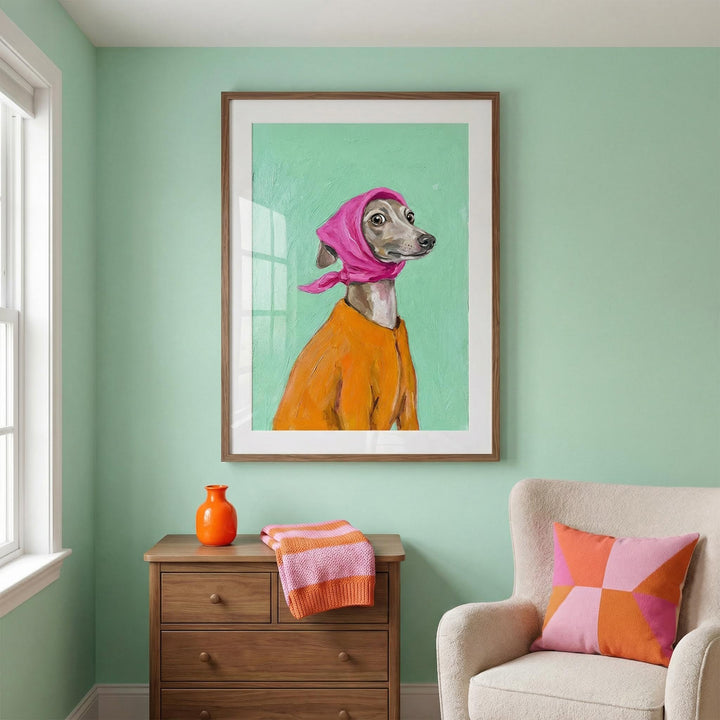 Greyhound Poster framed print of a greyhound wearing a pink headscarf and orange top above a wooden chest