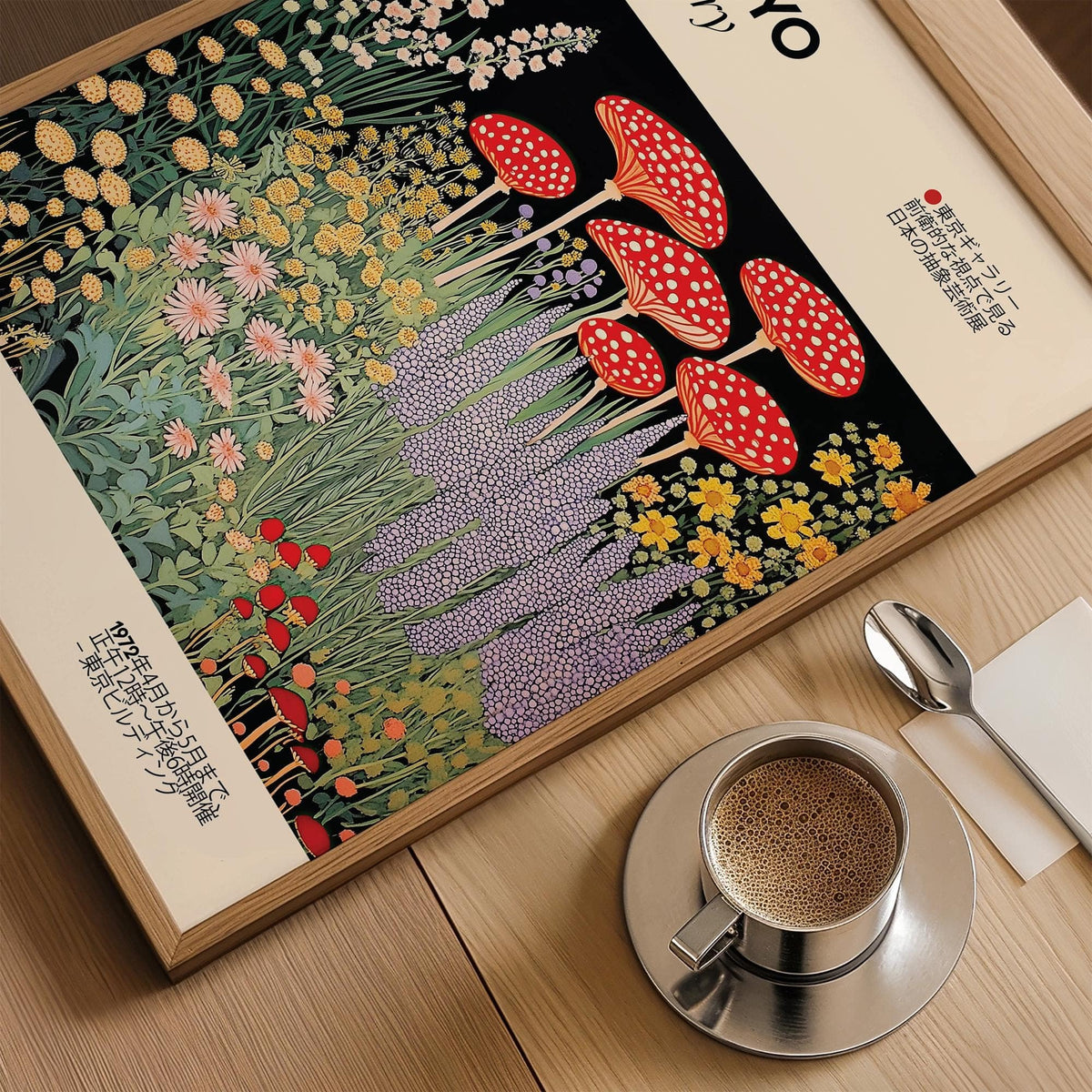 Close-up of Japanese Vintage Art print with red fly agaric mushrooms and yellow flowers beside a cup of coffee