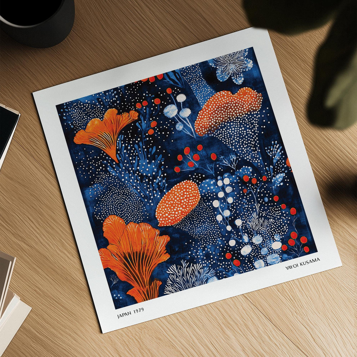Blue Orange wall art showing an orange floral pattern with white and red dots on a blue background on a wooden surface