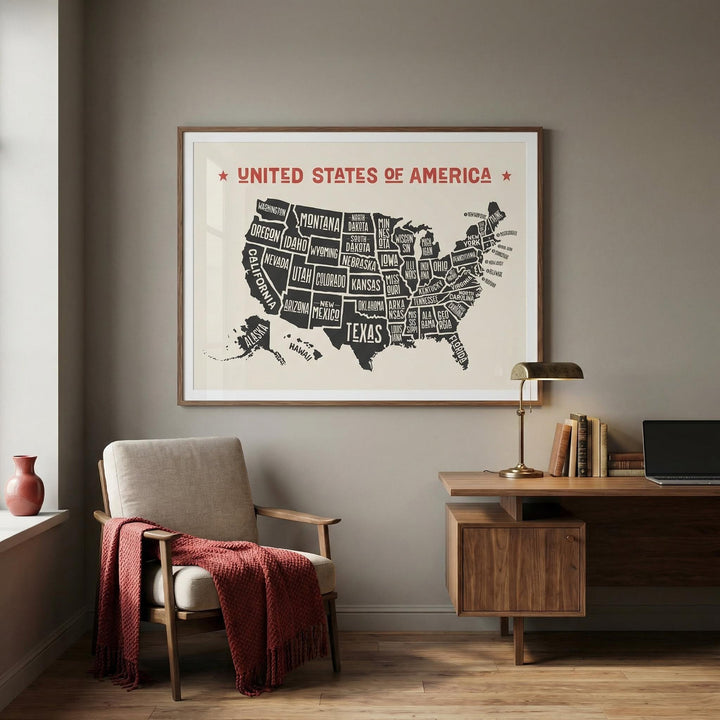 Us Map Poster on a wall above a writing desk and armchair with a red throw