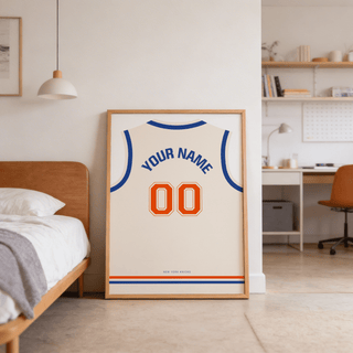 Basketball Jersey Poster in Cream with Orange Number leaning on the floor beside a wooden bed in a bedroom