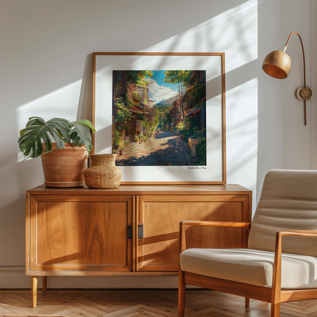 Prints Japanese Art wall art of a sunlit street view and Mount Fuji leaning on a wooden cabinet with a plant