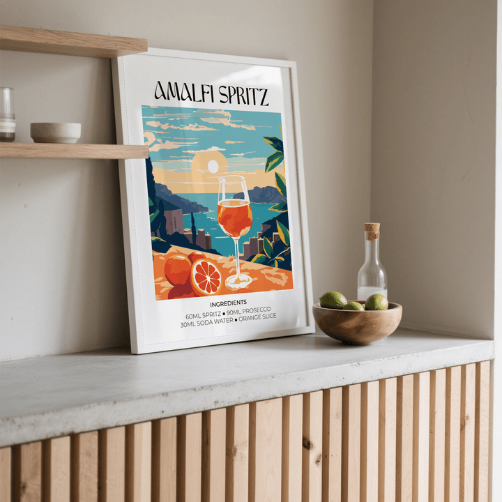 Cocktail Art Poster leaning on a shelf with an orange spritz cocktail illustration and nearby bowl of limes