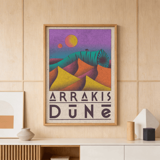 Desert Dunes Sci-Fi Poster framed print with vibrant purple and orange dunes on a wooden wall above a shelf with ceramics