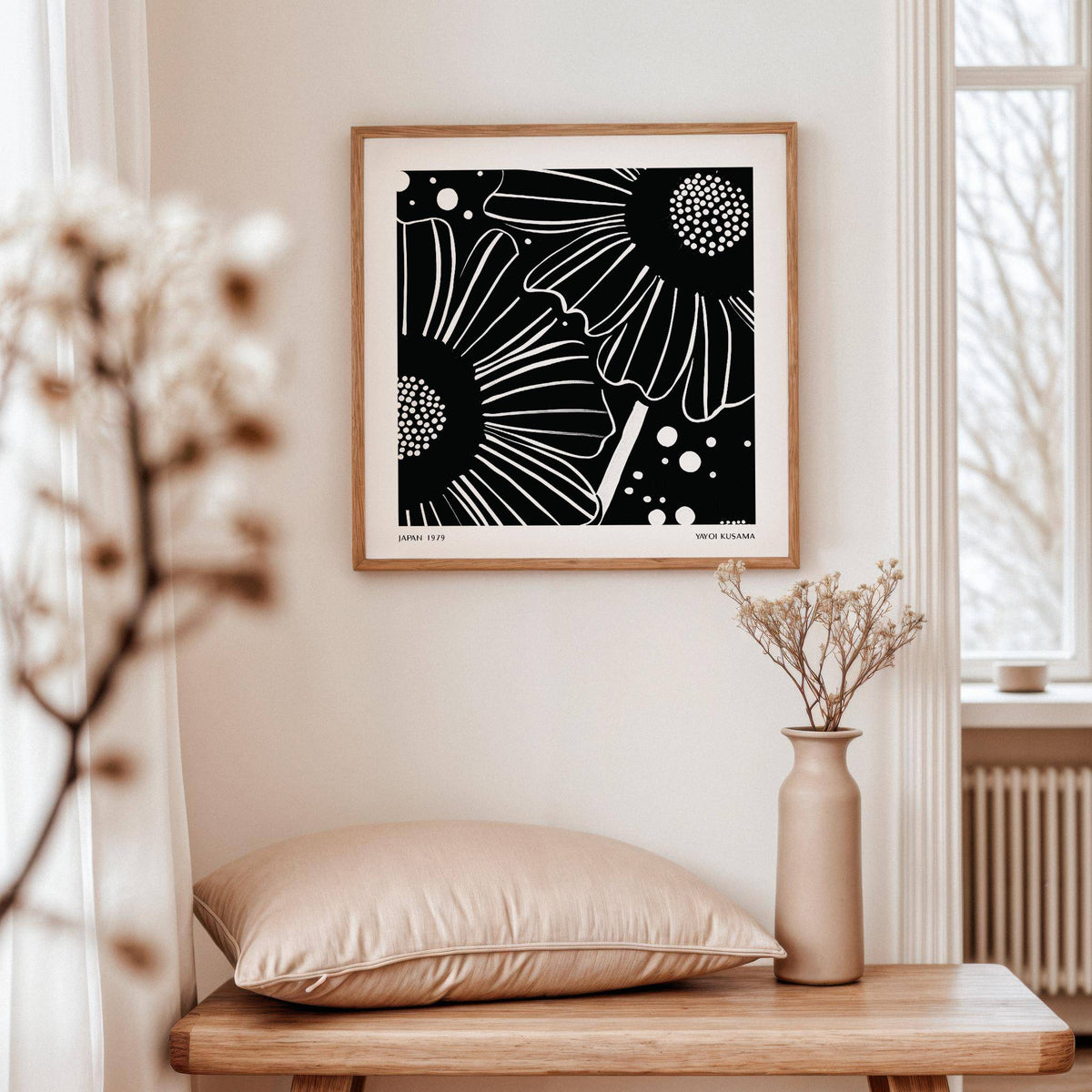 Print of black white floral art showing daisies with dots above a wooden bench and ceramic vase