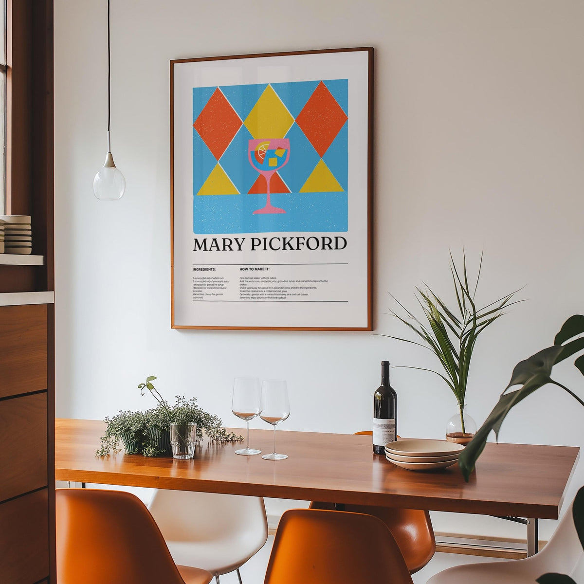 Pictures for Kitchen print of a pink cocktail glass with geometric diamond shapes above a dining table with orange chairs