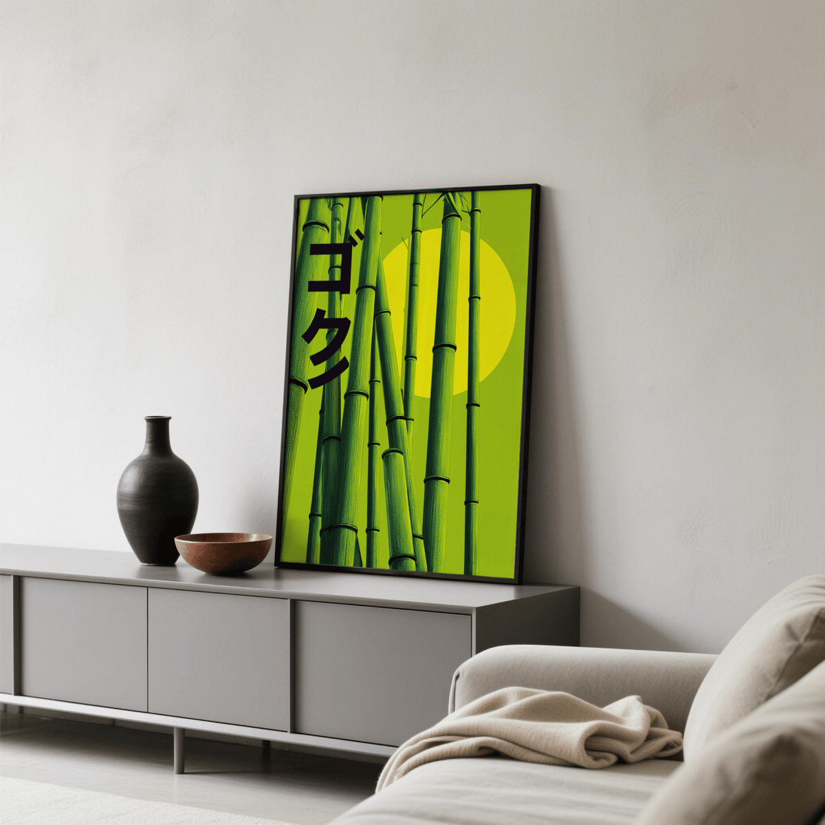 Green Bamboo Print leaning on a grey console with a black vase and brown bowl in a neutral living room