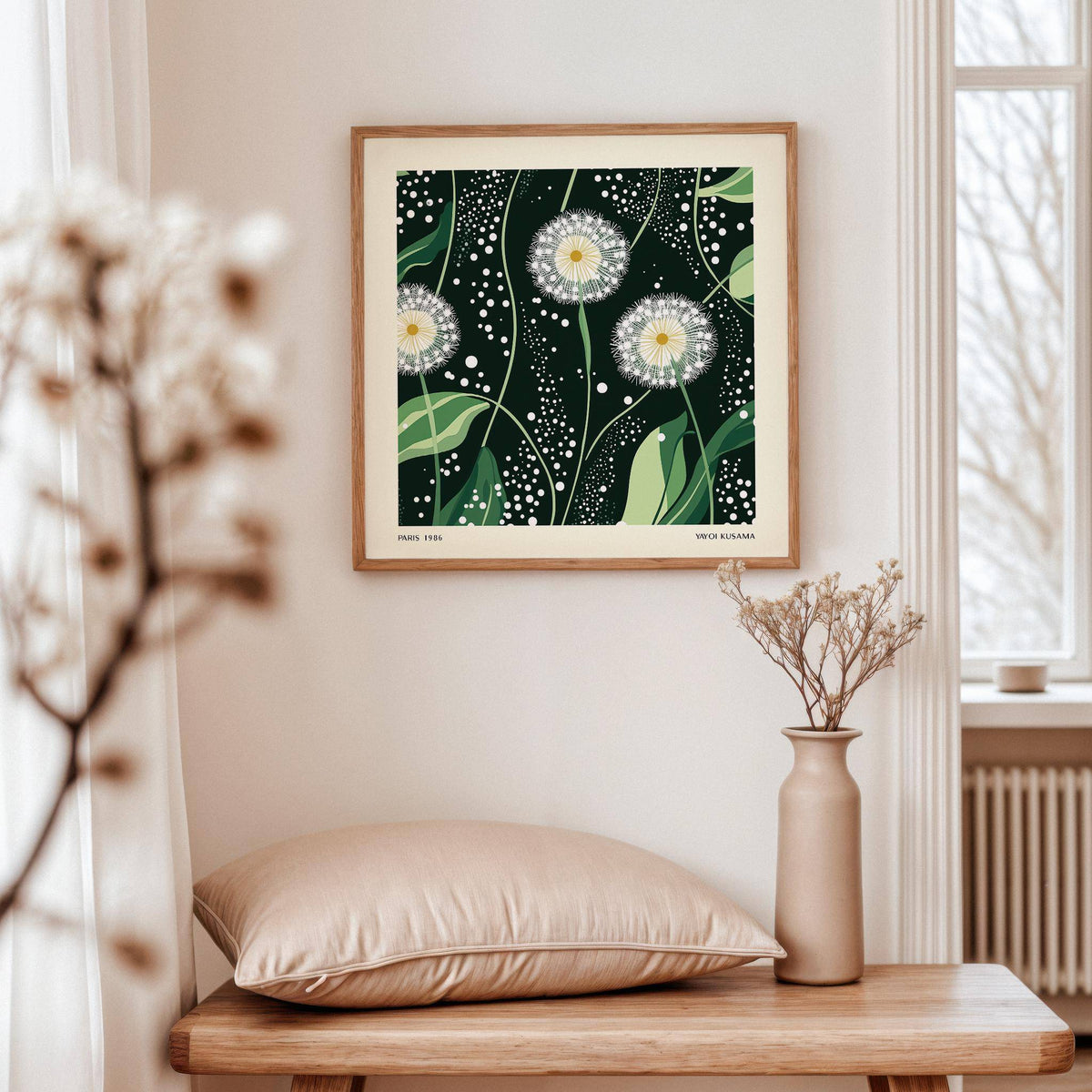 Green wall decor of dandelion seed heads with green leaves above a wooden bench with a cushion