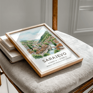 Framed Sarajevo City Print featuring a river and mosque leaning on a chair with books