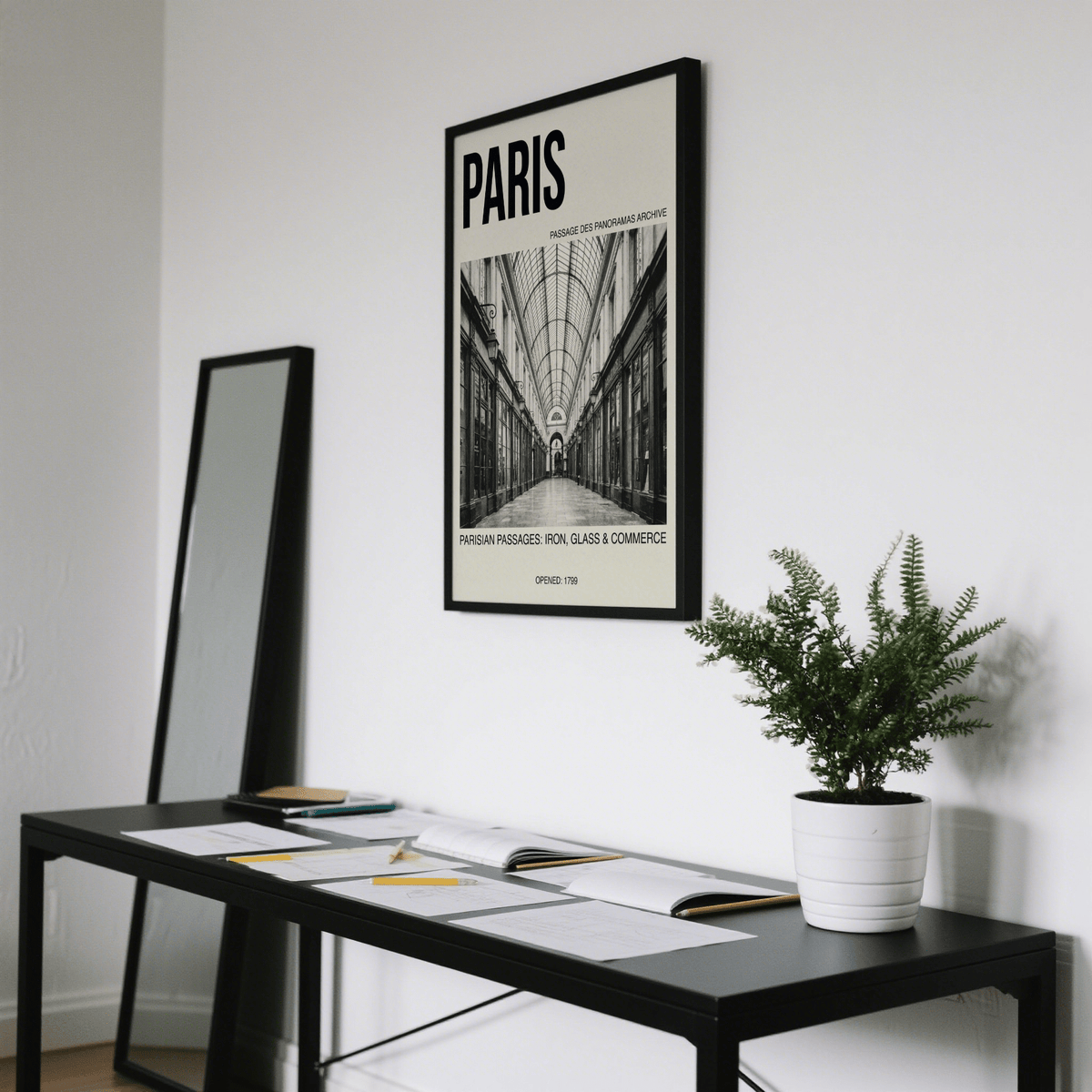 Parisian Passage Art Print on wall above black table with documents and potted plant