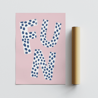 Fun typography wall art with white letters and blue spots on pink background beside a brown packaging tube