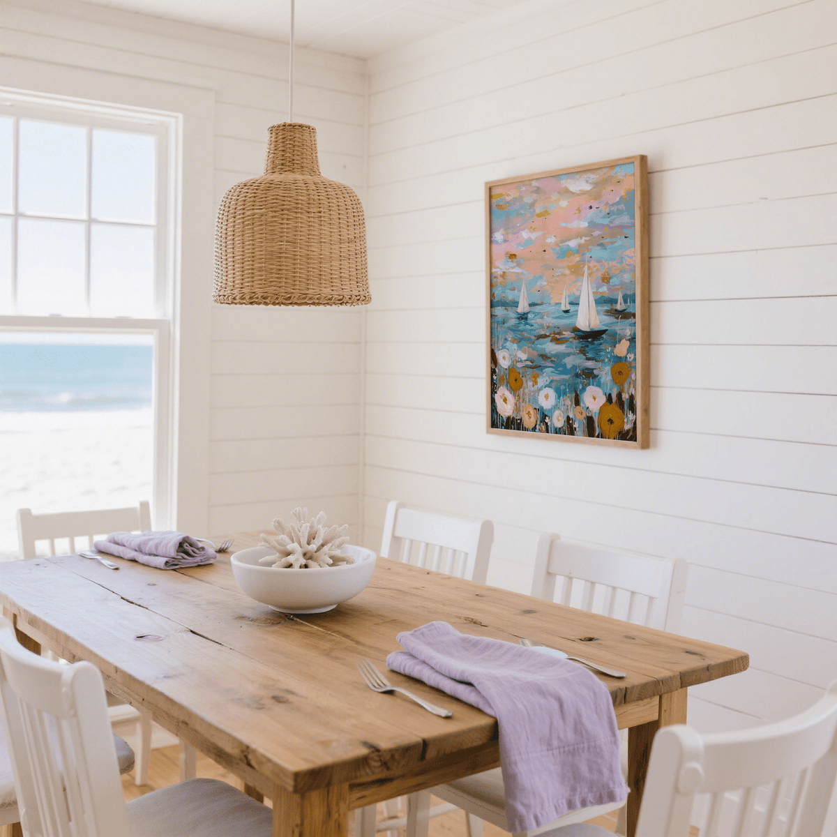Sailboat wall art of abstract sailboats on water with pink and blue tones in a bright dining room