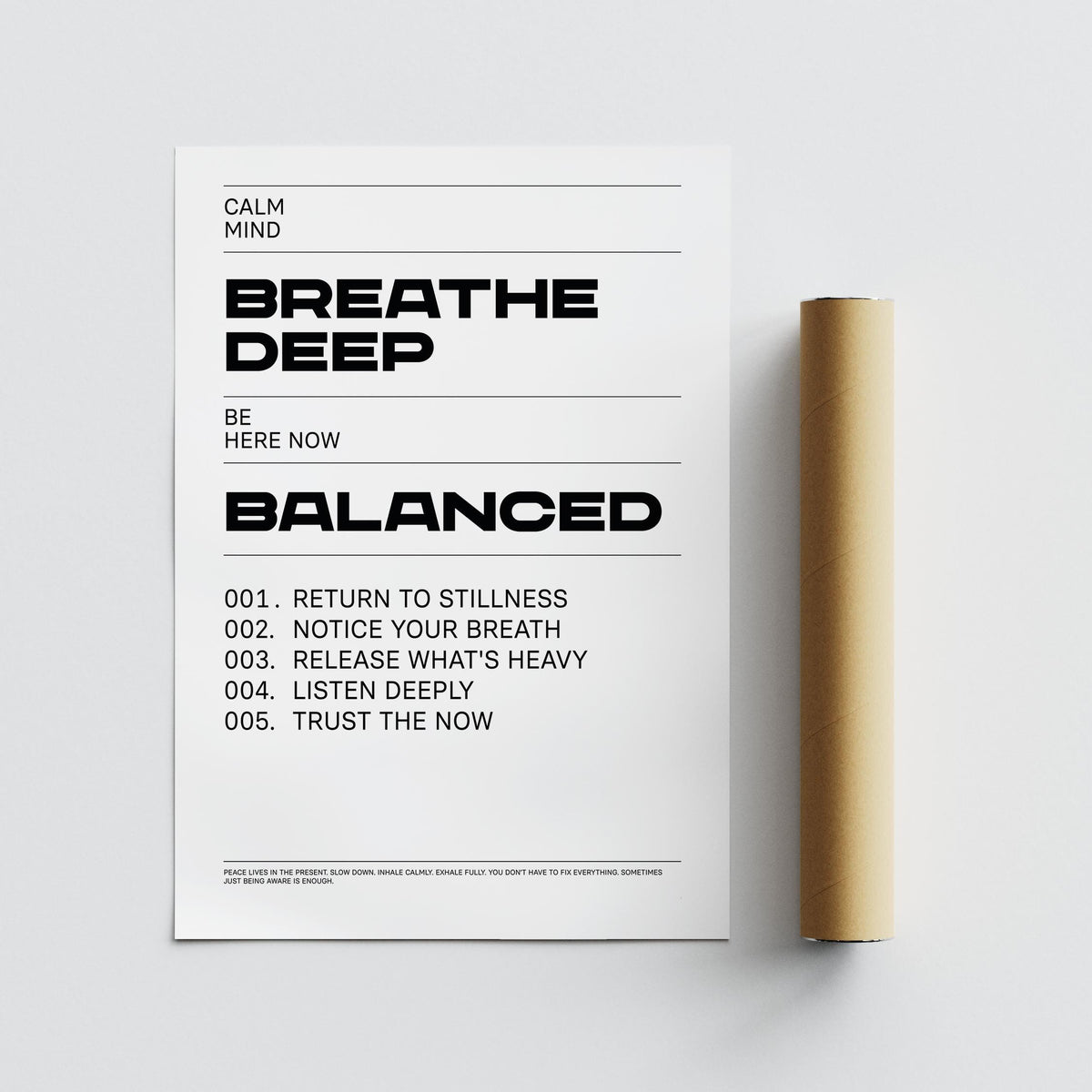 Close-up of typographic printed text with motivational phrases next to a brown packaging tube