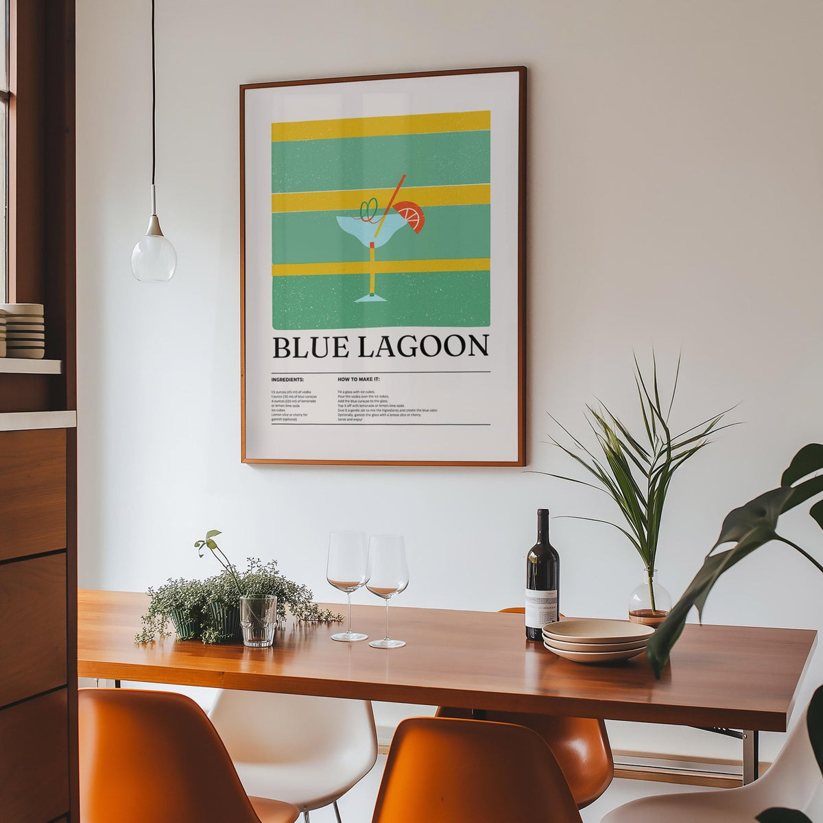 Kitchen wall pictures showing Blue Lagoon cocktail illustration above a wooden dining table with glasses and plants