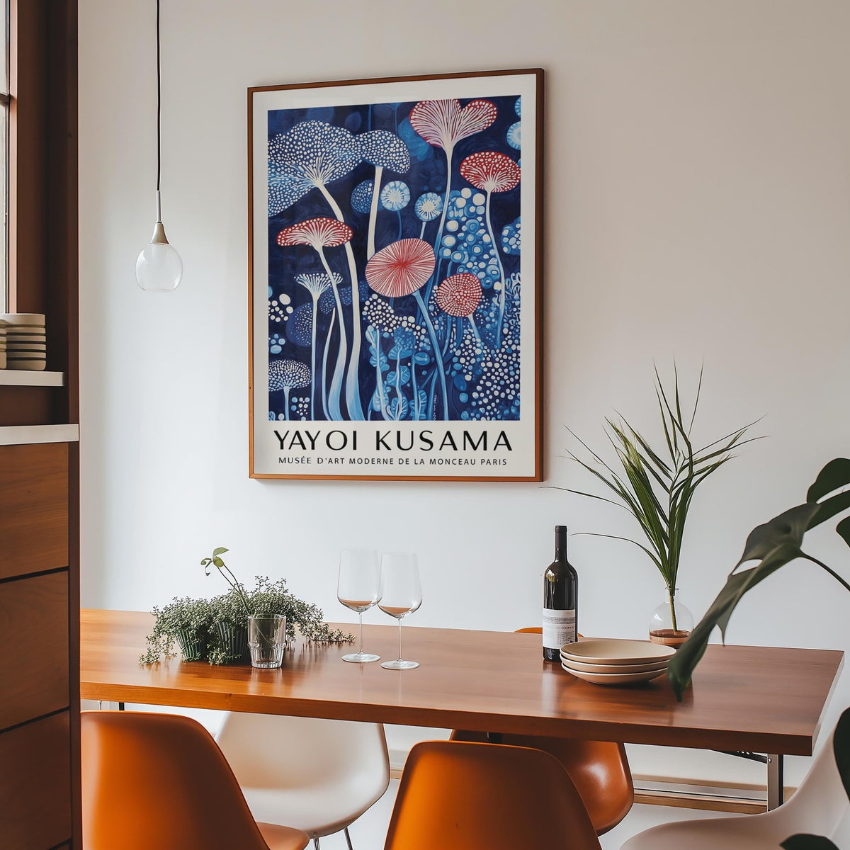 Mushroom art print featuring abstract mushrooms in blue and red above a dining table with glassware