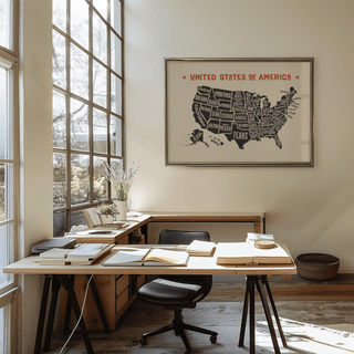 Us Map Poster print on a wall above a desk showing a minimalist typographic US states map in black and red
