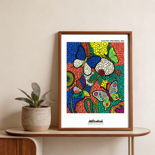Framed Colorful Butterfly Art Print with blue, green and orange abstract shapes leaning on a shelf with a plant pot