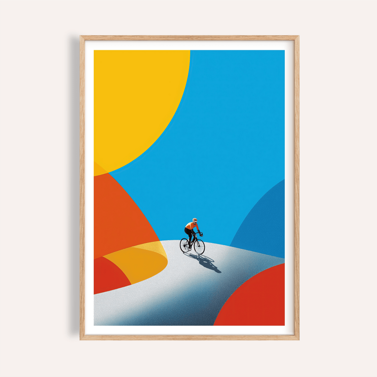 Framed cycling art print with minimalist cyclist on a winding road and bright blue and yellow shapes