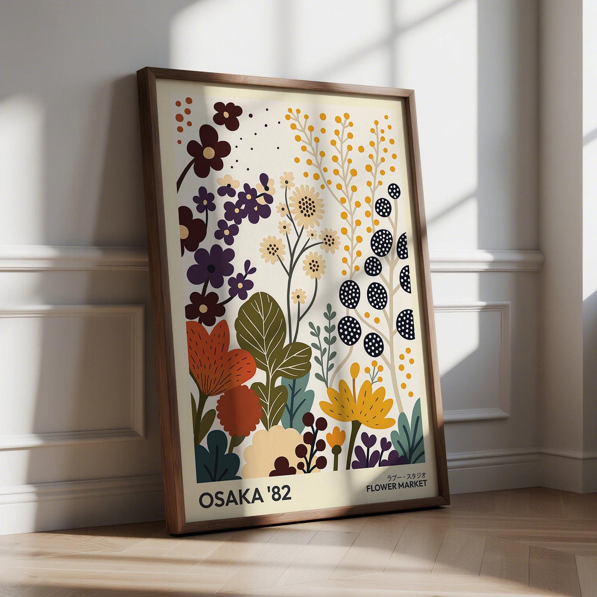 Flower prints art leaning on the floor with stylized floral bouquet in warm and muted colours