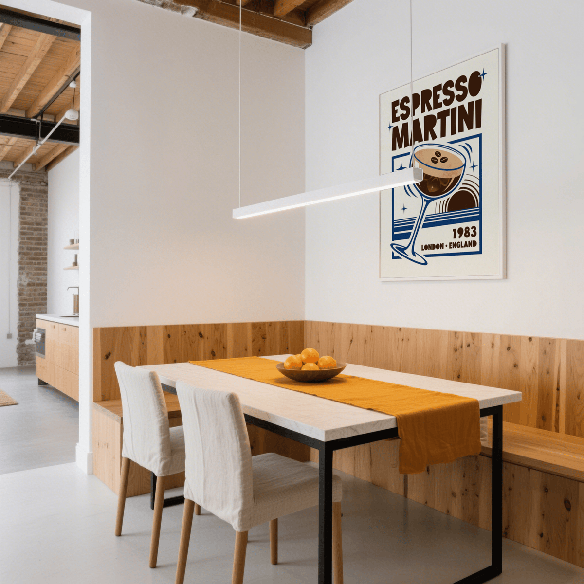 Espresso Martini Print on a dining room wall with wooden paneling and a bowl of oranges on table