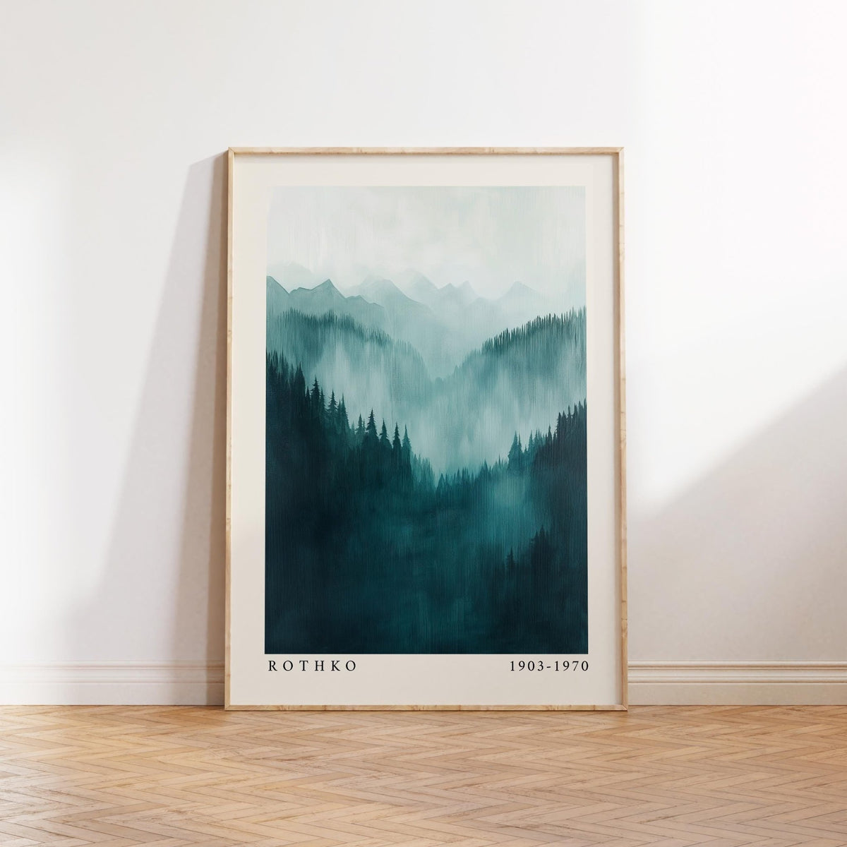 Mountain wall art showing a misty mountain range in blue-green hues leaning on a wooden parquet floor