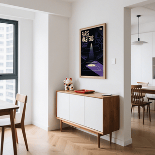 Paris Masters Art Print on a white wall above a wooden sideboard with a cat figurine and a red dish