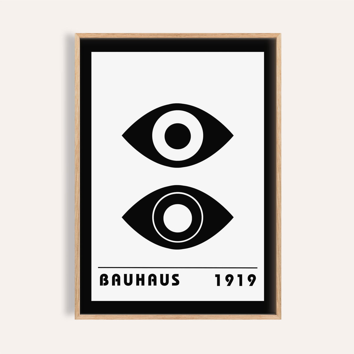 Bauhaus art print of stylized black eyes with minimalist typography in a light wood frame