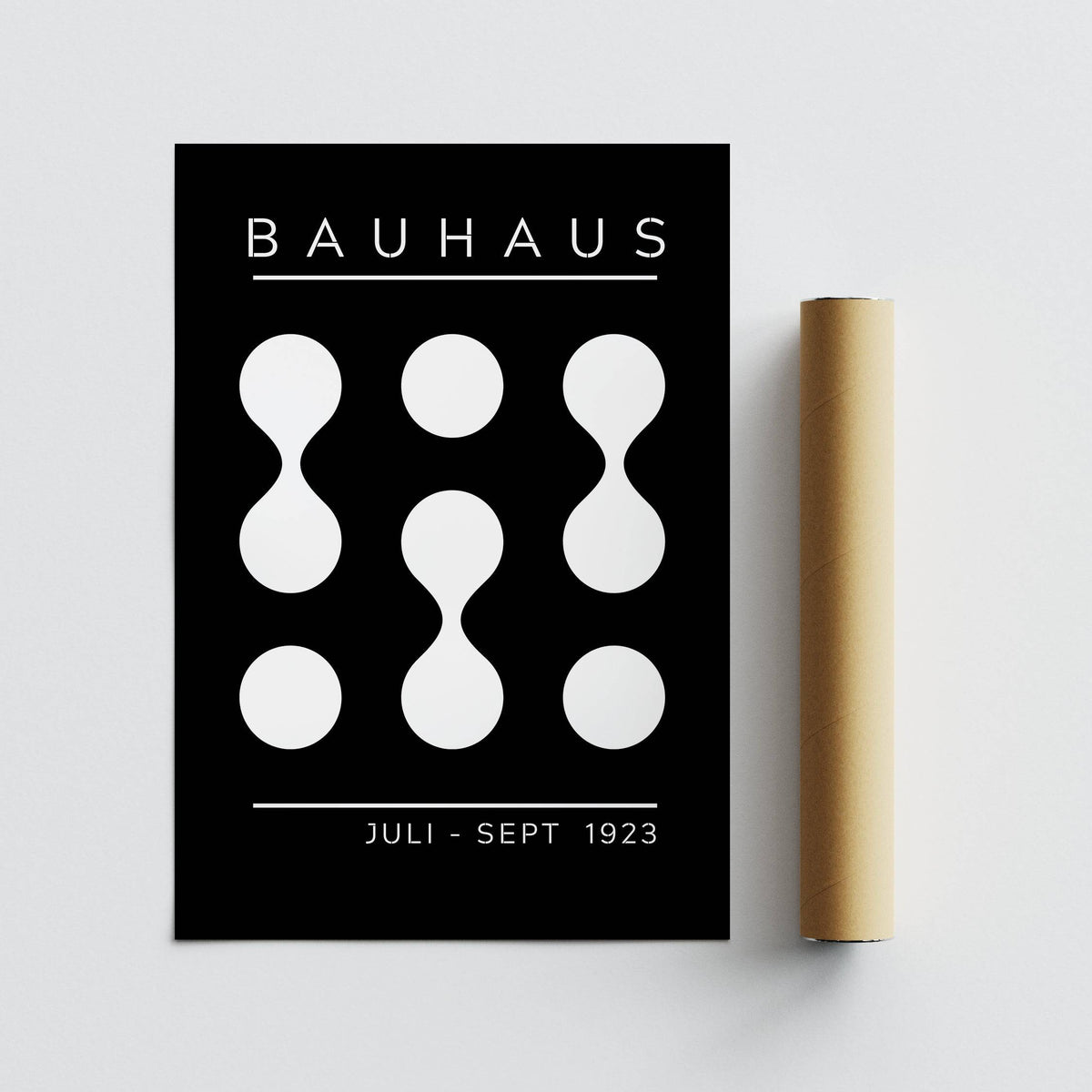 Black and White Geometric Art with abstract bauhaus shapes beside a brown packaging tube
