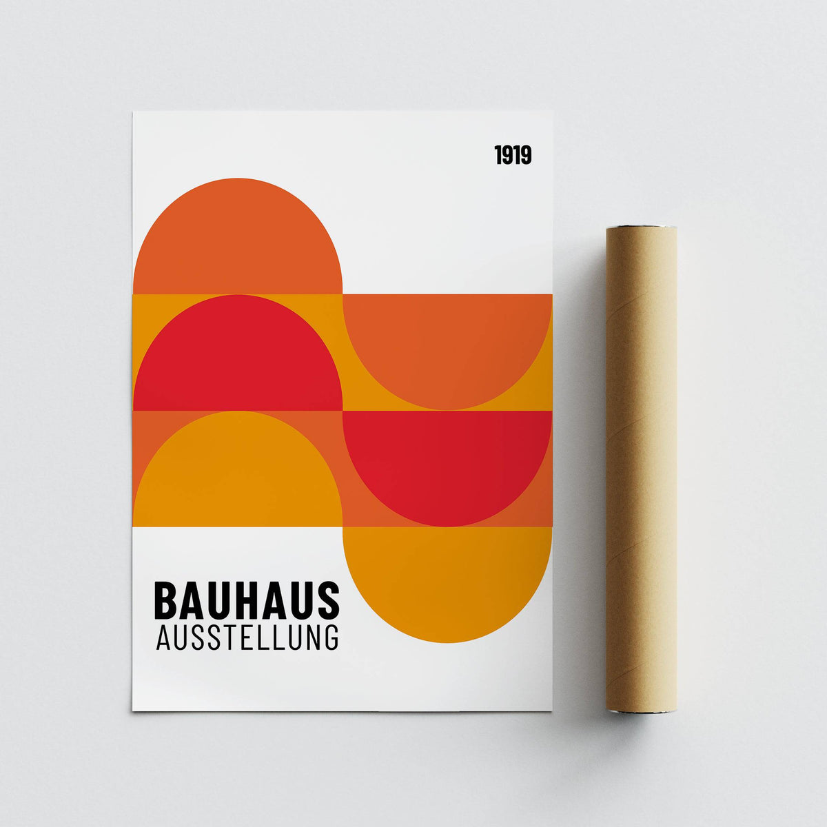 Inexpensive artwork with abstract geometric red and orange shapes next to a packaging tube