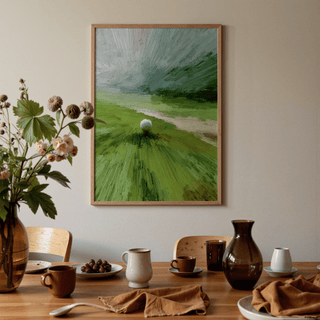 Abstract green wall art of a golf ball on tee in a dining room with a table setting and vase