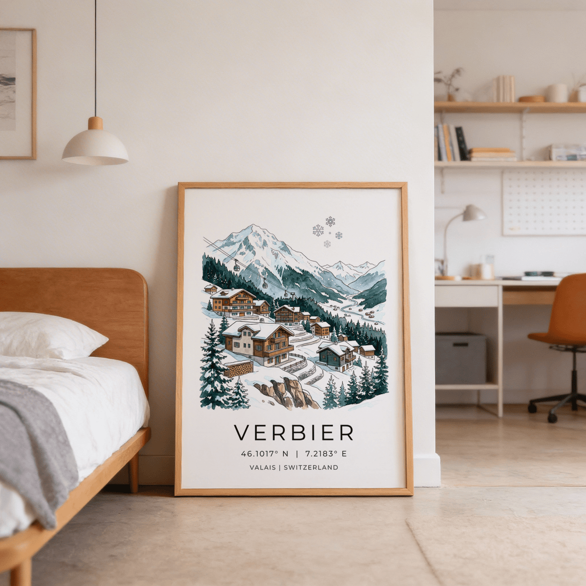 Print leaning on floor showing Verbier Mountain wall art with snow and pine trees next to a wooden bed