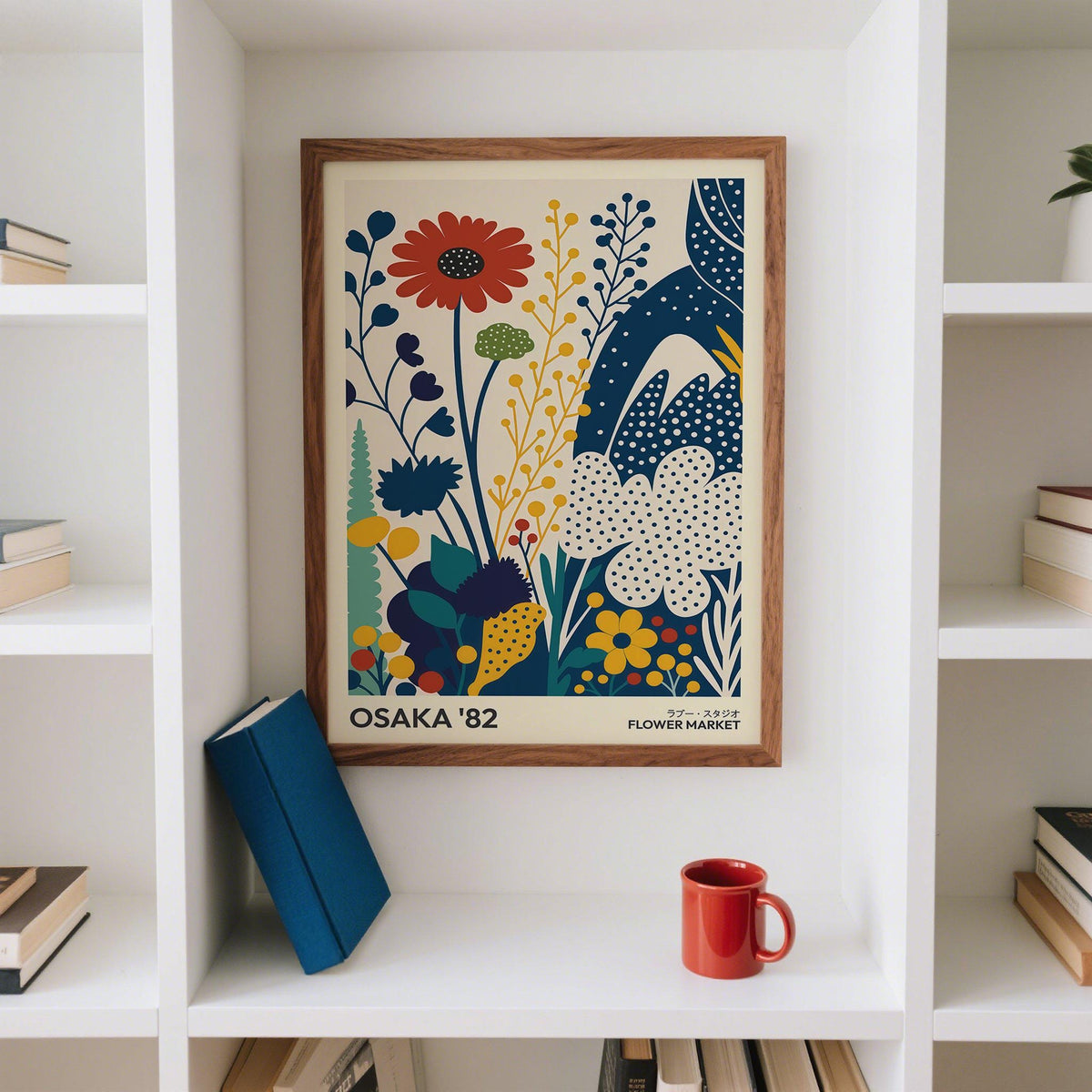 Poster Flowers wall art of a colourful stylised flower bouquet in a wooden frame on a white shelf with books and a red cup