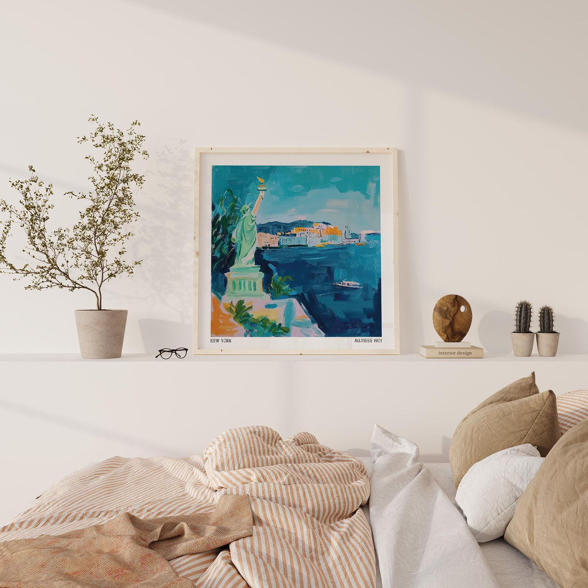 Holiday Posters print of the Statue of Liberty in blue and green tones above a shelf with plants in a bedroom