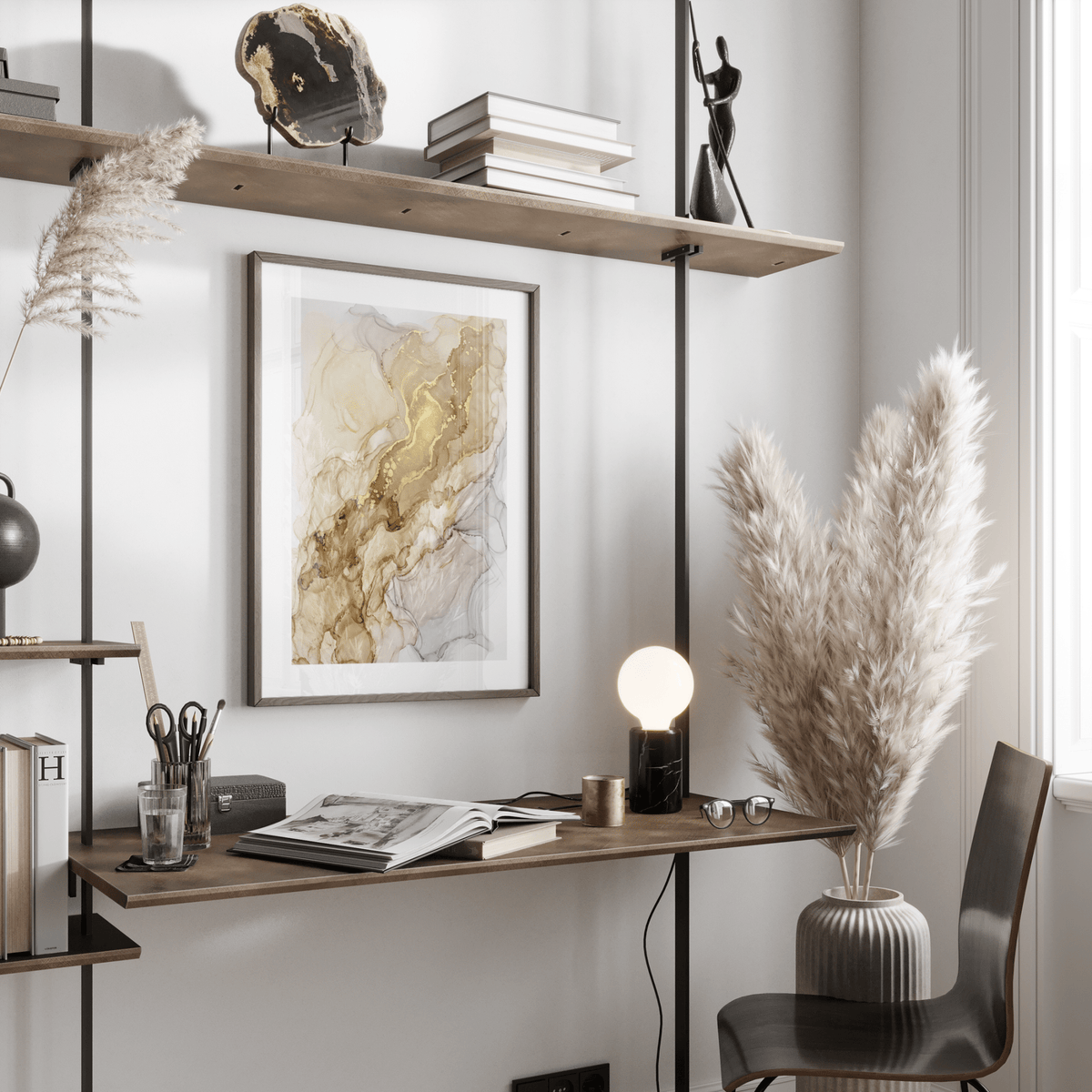 Framed Abstract Gold Art Print with gold swirls above a wooden desk with a lamp and books in a neutral room