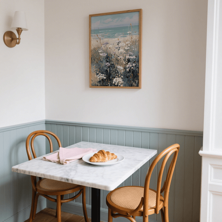 Wildflower Beach Print hanging on a cream wall above a dining table with a croissant and napkins