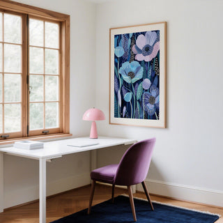 Blue and Purple Art framed print of stylized flowers in blue and purple above a white desk with a pink lamp in a bright room