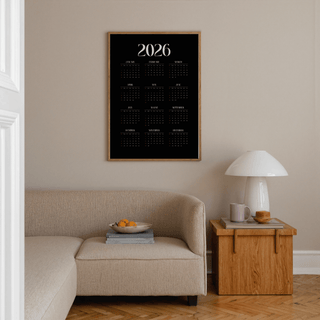 Modern Calendar Print in a minimalist living space with a beige sofa and wooden side table with a lamp