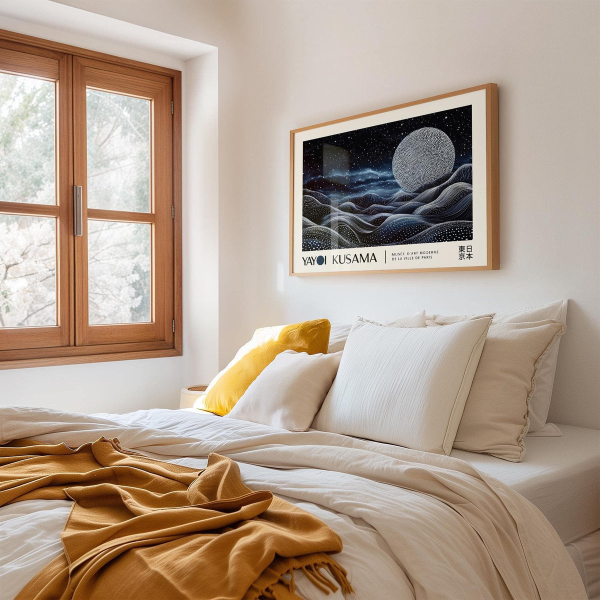 Space Art Wall print of a moon over abstract waves in black white and blue above a bed with pillows